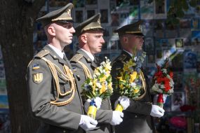Laying flowers at the Wall of Remembrance