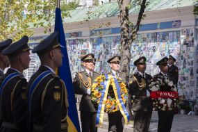Laying flowers at the Wall of Remembrance