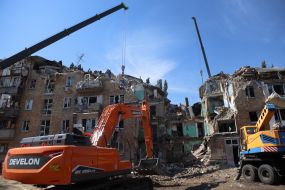Rescuers continue search and rescue operations in the ruins of a five-story residential building after nighttime shelling in the Darnytskyi district of Kyiv