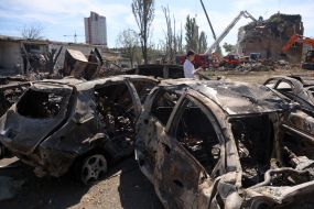 Burnt cars in a parking lot after night shelling in the Darnytskyi district of Kyiv