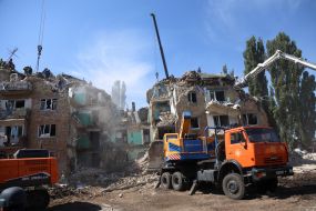 Rescuers continue search and rescue operations in the ruins of a five-story residential building after nighttime shelling in the Darnytskyi district of Kyiv