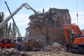 Rescuers continue search and rescue operations in the ruins of a five-story residential building after nighttime shelling in the Darnytskyi district of Kyiv