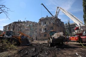 Rescuers continue search and rescue operations in the ruins of a five-story residential building after nighttime shelling in the Darnytskyi district of Kyiv