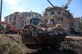 Rescuers continue search and rescue operations in the ruins of a five-story residential building after nighttime shelling in the Darnytskyi district of Kyiv