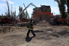 Rescuers continue search and rescue operations in the ruins of a five-story residential building after nighttime shelling in the Darnytskyi district of Kyiv