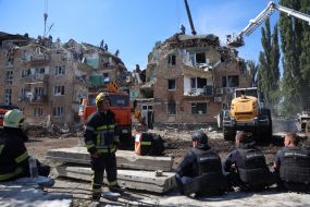 Rescuers continue search and rescue operations in the ruins of a five-story residential building after nighttime shelling in the Darnytskyi district of Kyiv