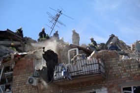 Rescuers continue search and rescue operations in the ruins of a five-story residential building after nighttime shelling in the Darnytskyi district of Kyiv