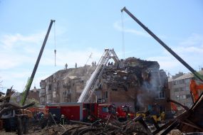 Rescuers continue search and rescue operations in the ruins of a five-story residential building after nighttime shelling in the Darnytskyi district of Kyiv