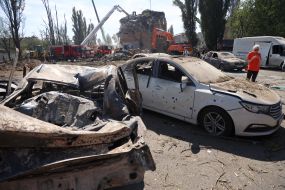 Burnt cars in a parking lot after night shelling in the Darnytskyi district of Kyiv