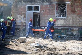 Rescuers continue search and rescue operations in the ruins of a five-story residential building after nighttime shelling in the Darnytskyi district of Kyiv