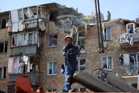 Rescuers continue search and rescue operations in the ruins of a five-story residential building after nighttime shelling in the Darnytskyi district of Kyiv