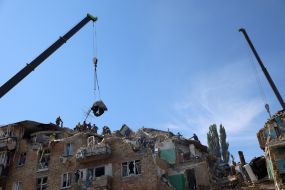 Rescuers continue search and rescue operations in the ruins of a five-story residential building after nighttime shelling in the Darnytskyi district of Kyiv