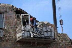 Rescuers continue search and rescue operations in the ruins of a five-story residential building after nighttime shelling in the Darnytskyi district of Kyiv