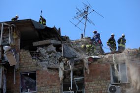 Rescuers continue search and rescue operations in the ruins of a five-story residential building after nighttime shelling in the Darnytskyi district of Kyiv