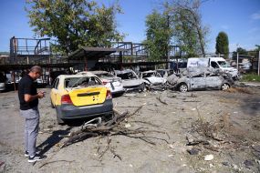 Burnt cars in a parking lot after night shelling in the Darnytskyi district of Kyiv