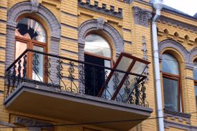 Broken doors and windows in a house after night shelling in Kyiv