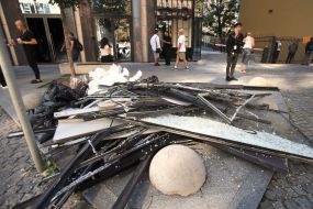 Fragments of window frames and glass on the ground near a house after night shelling in Kyiv