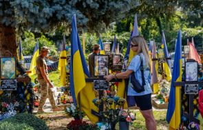 Woman near the grave of a soldier
