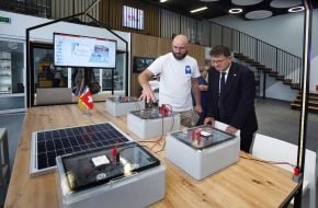 Maksim Podzhariy shows Felix Baumann the electrician's training place