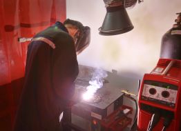 An apprentice performs welding work