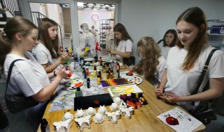 Students color parts made on a 3D printer