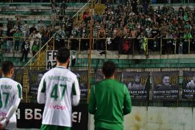 Players of FC Karpaty (Lviv) thank fans near portraits of fallen military on the stand