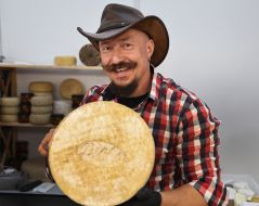 Man holding a head of cheese