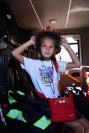 A girl tries on a lifeguard helmet