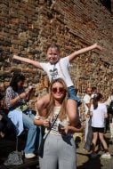 Woman holding a girl on her shoulders