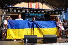 Festival participants hold the flag of Ukraine