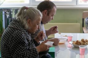 Elderly woman and man having lunch in the dining room