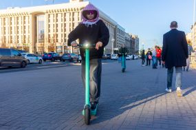 A young man on an electric scooter