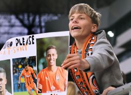 A teenager holds a poster in support of FC Shakhtar (Donetsk)