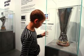 A boy looks at the UEFA Cup (held by FC Shakhtar Donetsk)