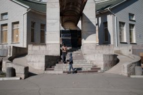 A building with windows boarded up with plywood in Kherson