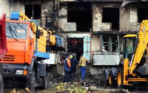 The half-destroyed and burnt facade of a residential building after a nighttime drone attack in the Desnyanskyi district of Kyiv