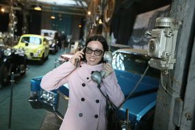 Woman holding a retro telephone receiver in her hands