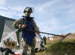 A veteran adjusts his gear.