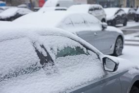 Snow-covered cars on the street in Kiev
