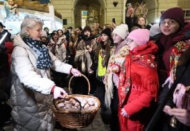 Kateryna Kit-Sadova distributes Christmas donuts to children