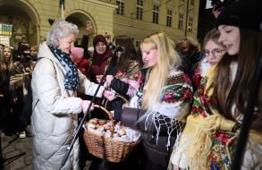 Kateryna Kit-Sadova distributes Christmas donuts to children