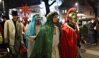 Participants of the Christmas Nativity Scene sing carols