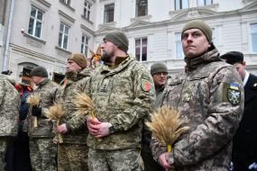 Military personnel and veterans during a festive procession