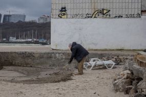 Environmentalists clean up oil slick on the beach in Odessa