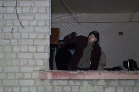 A man in his apartment, damaged by Russian shelling
