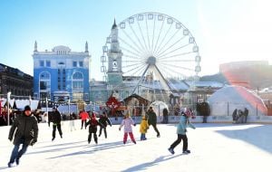 Children and adults at the skating rink on Kontraktova Square in Kyiv