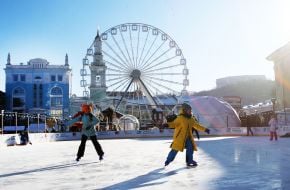 Children and adults at the skating rink on Kontraktova Square in Kyiv