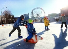 Children and adults at the skating rink on Kontraktova Square in Kyiv