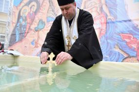 A military chaplain blesses water in a reservoir on the feast of the Epiphany at Rynok Square in Lviv