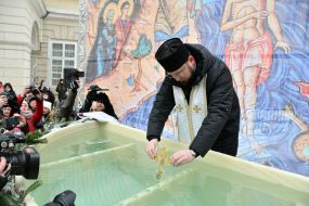 A military chaplain blesses water in a reservoir on the feast of the Epiphany at Rynok Square in Lviv